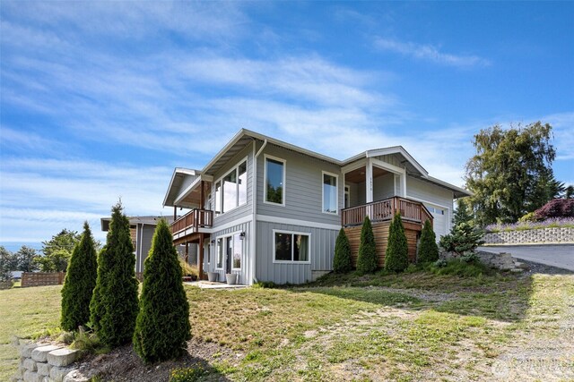 1575 Kingsley Ave, Blaine, WA 98230 - view of property exterior with a balcony, a lawn, and board and batten siding