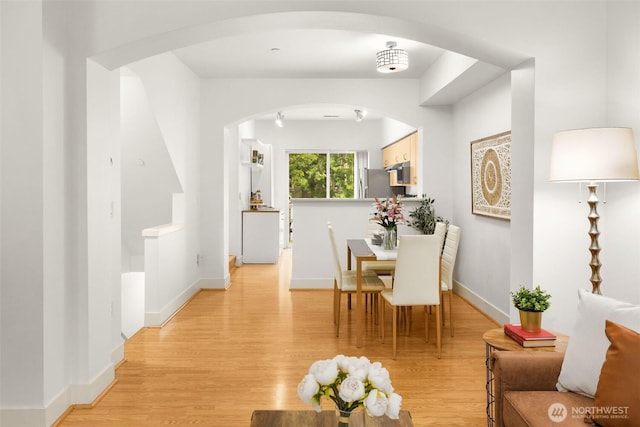 18223 NE 95th Way Unit 102, Redmond, WA 98052 - dining room featuring arched walkways and light wood-style flooring
