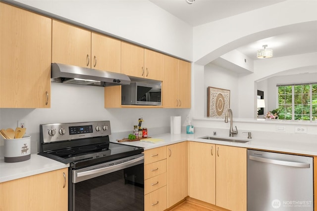 18223 NE 95th Way Unit 102, Redmond, WA 98052 - kitchen with appliances with stainless steel finishes, under cabinet range hood, light brown cabinetry, and light countertops
