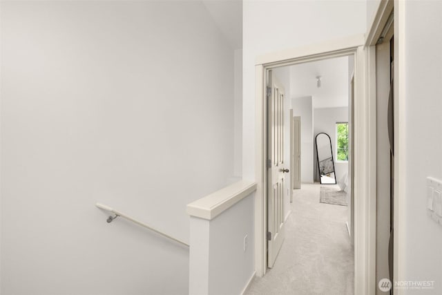 18223 NE 95th Way Unit 102, Redmond, WA 98052 - hallway featuring an upstairs landing and light colored carpet