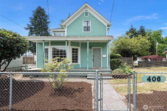 406 4th St NE, Puyallup, WA 98372 - view of front facade featuring covered porch, a gate, and a fenced front yard