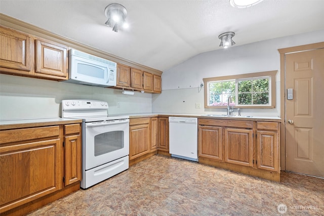 406 4th St NE, Puyallup, WA 98372 - kitchen featuring white appliances, lofted ceiling, light countertops, and brown cabinets