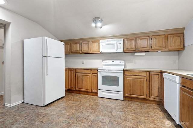 406 4th St NE, Puyallup, WA 98372 - kitchen featuring white appliances, light countertops, brown cabinetry, and lofted ceiling