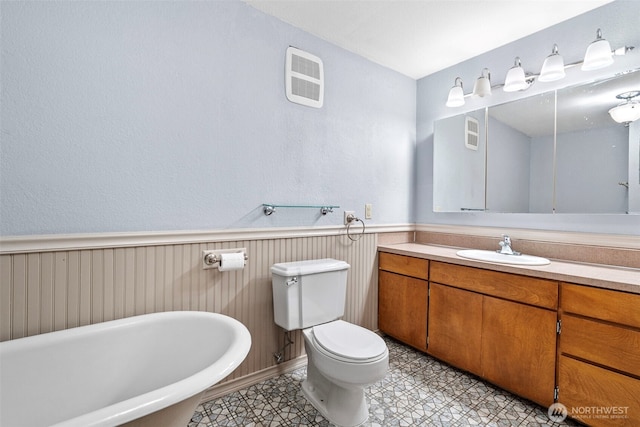 406 4th St NE, Puyallup, WA 98372 - bathroom featuring a freestanding bath, vanity, and a wainscoted wall
