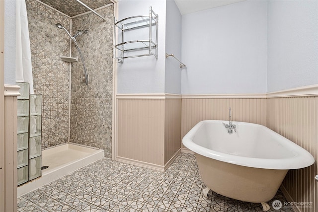 406 4th St NE, Puyallup, WA 98372 - bathroom with a wainscoted wall, a soaking tub, and a tile shower