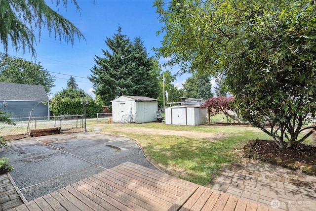 406 4th St NE, Puyallup, WA 98372 - wooden deck featuring a shed, a patio area, and a gate