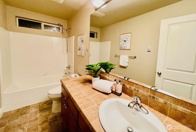 6802 156th Pl NE, Redmond, WA 98052 - bathroom featuring vanity, washtub / shower combination, stone finish flooring, and tasteful backsplash