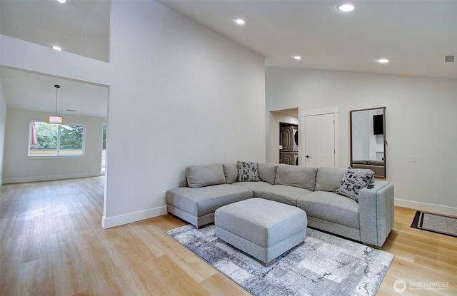 1611 NE 113th St Unit 421, Vancouver, WA 98686 - living room featuring high vaulted ceiling, stacked washer / drying machine, light wood-style floors, and recessed lighting