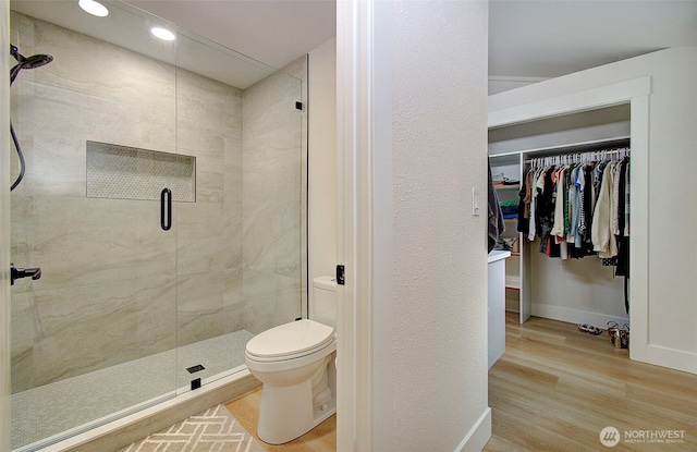 1611 NE 113th St Unit 421, Vancouver, WA 98686 - full bathroom featuring wood finished floors, a shower stall, a walk in closet, and recessed lighting