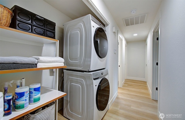 1611 NE 113th St Unit 421, Vancouver, WA 98686 - washroom featuring stacked washing machine and dryer and light wood finished floors
