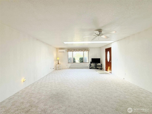 4905 US Highway 12, Elma, WA 98541 - unfurnished living room with a baseboard heating unit, carpet, ceiling fan, an AC wall unit, and a textured ceiling