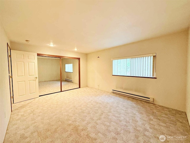 4905 US Highway 12, Elma, WA 98541 - unfurnished bedroom with a baseboard radiator, carpet flooring, multiple windows, and recessed lighting
