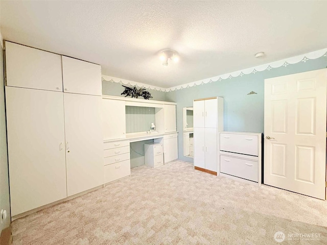 4905 US Highway 12, Elma, WA 98541 - unfurnished bedroom featuring light carpet, a textured ceiling, and a desk