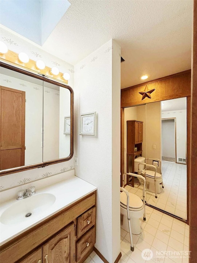 4905 US Highway 12, Elma, WA 98541 - bathroom featuring vanity, a textured ceiling, and tile patterned flooring