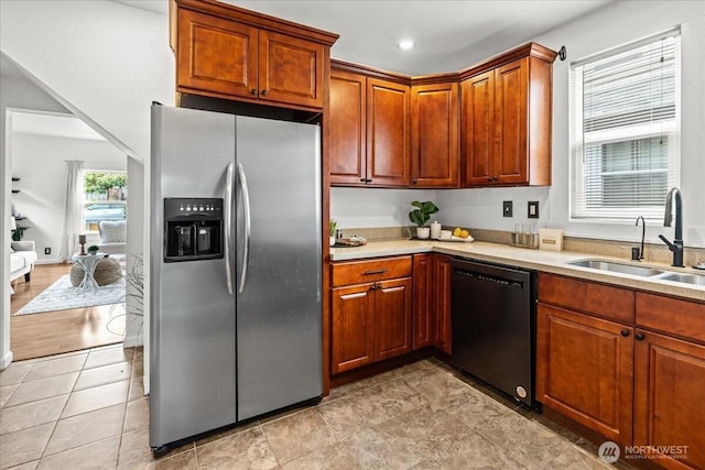 820 S Ferry St, Tacoma, WA 98405 - kitchen featuring stainless steel fridge, black dishwasher, light countertops, and brown cabinetry