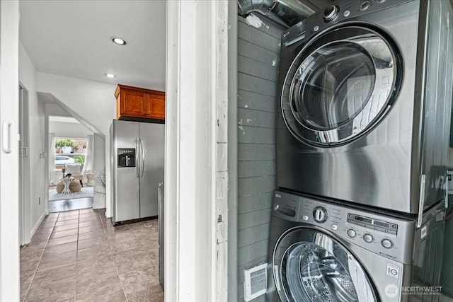 820 S Ferry St, Tacoma, WA 98405 - laundry area featuring estacked washer and dryer, light tile patterned floors, and recessed lighting