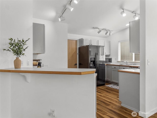 839 Avalon Ct SE, Olympia, WA 98513 - kitchen with stainless steel appliances, rail lighting, a peninsula, dark wood-style flooring, and a breakfast bar area