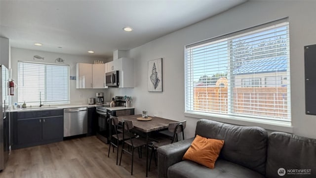 890 Magellan Ave NE Unit 3, Ocean Shores, WA 98569 - kitchen featuring appliances with stainless steel finishes, light wood-type flooring, light countertops, recessed lighting, and open floor plan