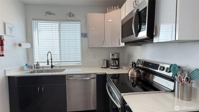 890 Magellan Ave NE Unit 3, Ocean Shores, WA 98569 - kitchen featuring stainless steel appliances, plenty of natural light, and light countertops