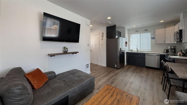 890 Magellan Ave NE Unit 3, Ocean Shores, WA 98569 - living room with light wood-style floors and recessed lighting