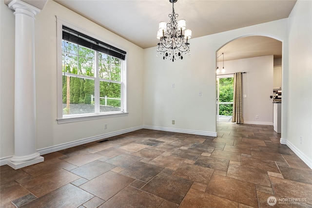 1007 Brookings Pl, Bellingham, WA 98229 - spare room featuring arched walkways, stone tile flooring, and a chandelier