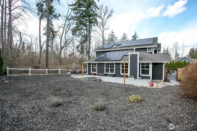 1007 Brookings Pl, Bellingham, WA 98229 - rear view of property featuring a patio area, solar panels, a shingled roof, a fenced backyard, and a gate