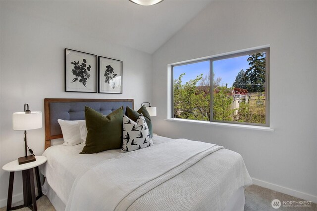 5929 California Ave SW Unit B, Seattle, WA 98136 - carpeted bedroom featuring vaulted ceiling and baseboards