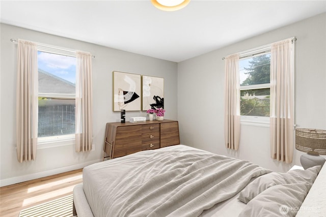 19410 10th Ave S, Des Moines, WA 98148 - bedroom featuring wood finished floors and multiple windows