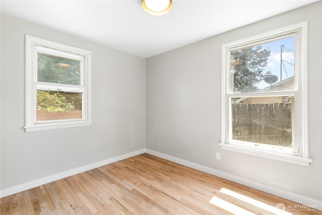 19410 10th Ave S, Des Moines, WA 98148 - empty room with healthy amount of natural light and wood finished floors