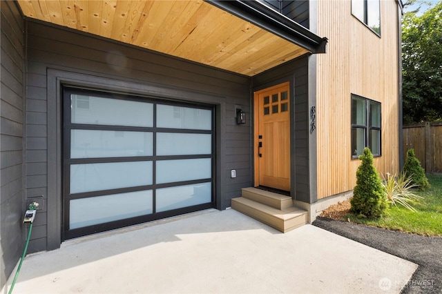826 NE 95th St, Seattle, WA 98115 - view of exterior entry with a garage and concrete driveway