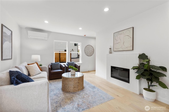 826 NE 95th St, Seattle, WA 98115 - living area with a wall unit AC, wood finished floors, recessed lighting, and a glass covered fireplace