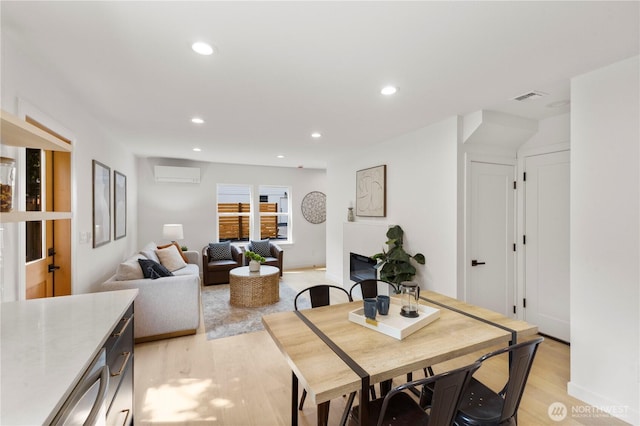 826 NE 95th St, Seattle, WA 98115 - dining area with an AC wall unit, light wood-style floors, and recessed lighting