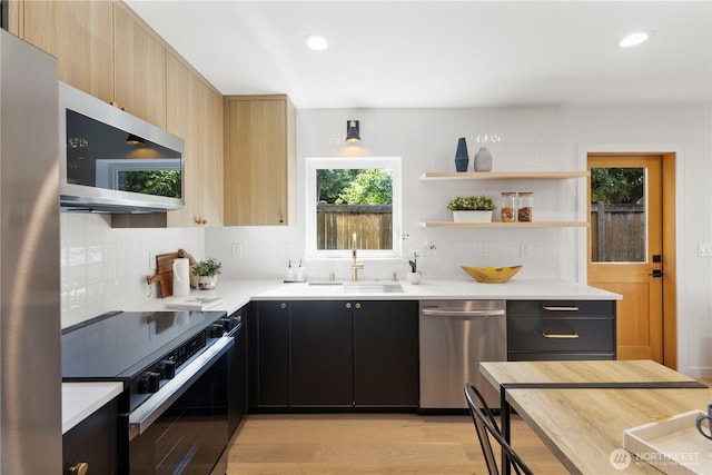 826 NE 95th St, Seattle, WA 98115 - kitchen featuring appliances with stainless steel finishes, backsplash, light countertops, dark cabinetry, and light brown cabinetry