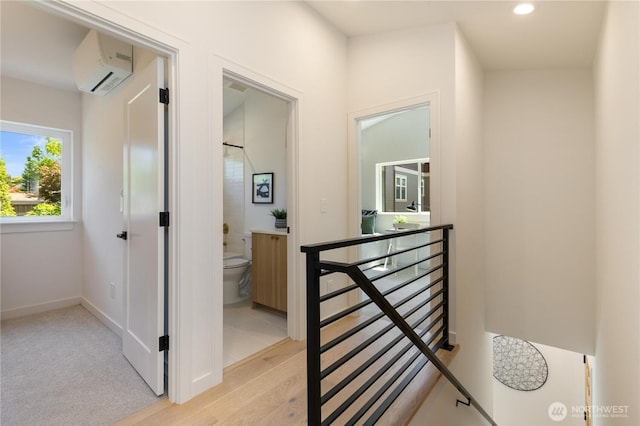 826 NE 95th St, Seattle, WA 98115 - corridor featuring an upstairs landing, a wall unit AC, light wood finished floors, and recessed lighting