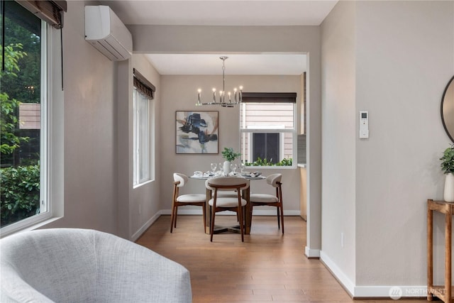 1600 11th Ave S, Seattle, WA 98134 - dining area with a wall unit AC, wood finished floors, and a chandelier
