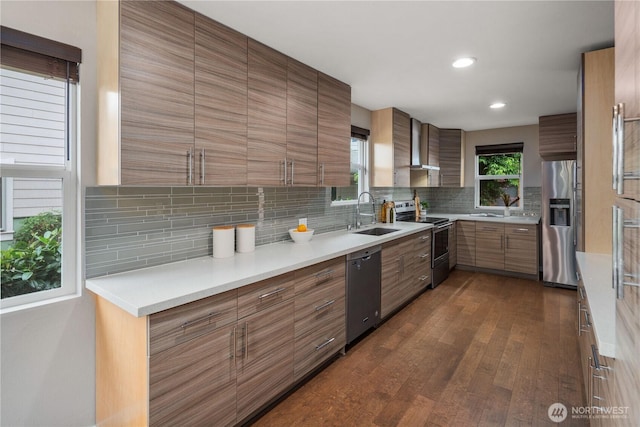 1600 11th Ave S, Seattle, WA 98134 - kitchen featuring appliances with stainless steel finishes, dark wood-style flooring, decorative backsplash, brown cabinets, and wall chimney exhaust hood