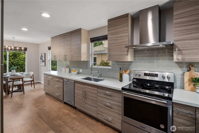 1600 11th Ave S, Seattle, WA 98134 - kitchen with stainless steel appliances, wall chimney range hood, light countertops, backsplash, and healthy amount of natural light
