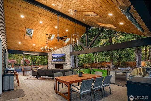 43936 SE 127th Pl, North Bend, WA 98045 - wooden terrace with an outdoor living space with a fireplace, outdoor dining area, a ceiling fan, and area for grilling