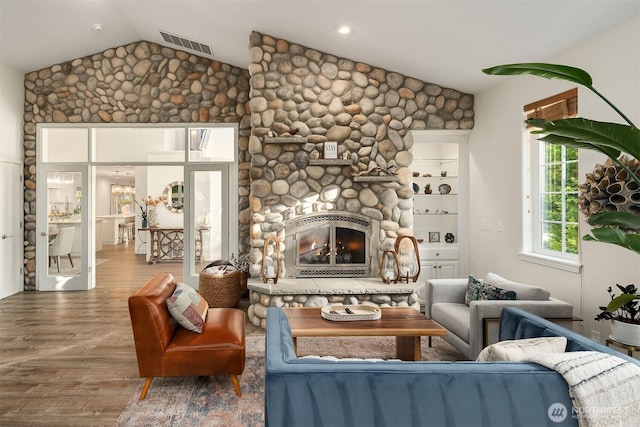 43936 SE 127th Pl, North Bend, WA 98045 - living room with vaulted ceiling, wood finished floors, and a stone fireplace