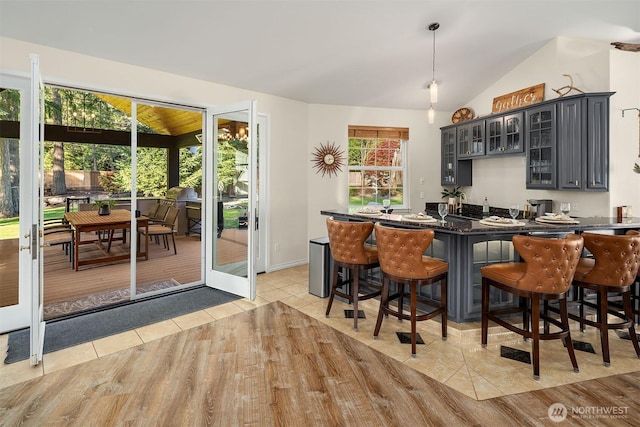 43936 SE 127th Pl, North Bend, WA 98045 - bar area featuring vaulted ceiling, light tile patterned floors, and decorative light fixtures