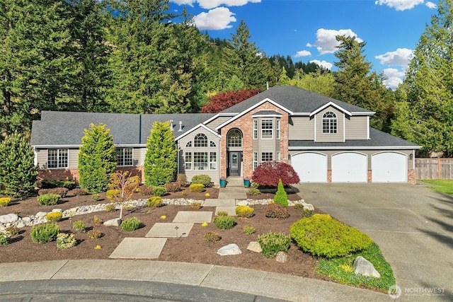 43936 SE 127th Pl, North Bend, WA 98045 - traditional-style home featuring asphalt driveway, brick siding, an attached garage, and roof with shingles