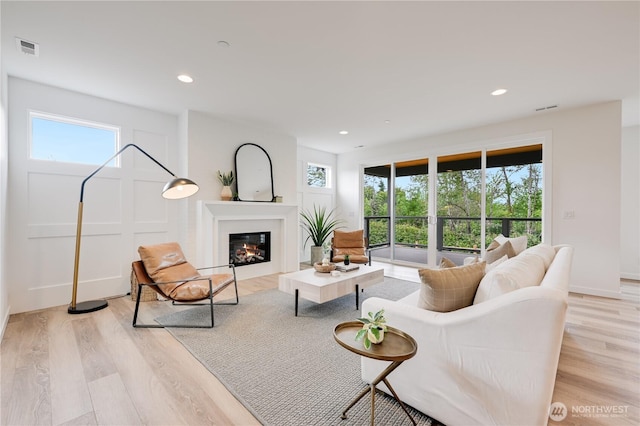 30408 SE 304th St, Auburn, WA 98038 - living area with light wood-style floors, a glass covered fireplace, and recessed lighting