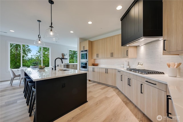 30408 SE 304th St, Auburn, WA 98038 - kitchen with light brown cabinetry, custom exhaust hood, light wood-type flooring, tasteful backsplash, and recessed lighting