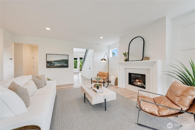 30408 SE 304th St, Auburn, WA 98038 - living room with light wood-style flooring, a glass covered fireplace, and recessed lighting