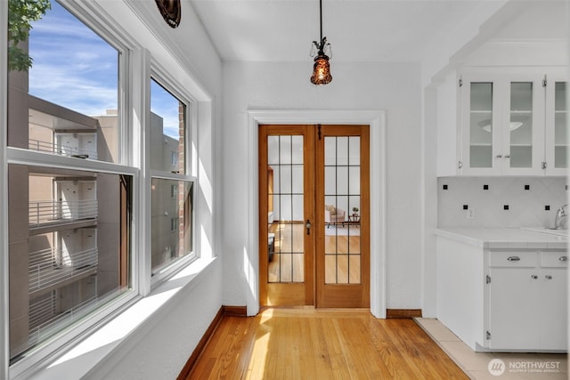 519 W Roy St Unit 211, Seattle, WA 98119 - doorway with light wood-style floors and baseboards