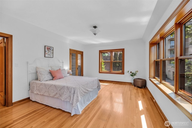 519 W Roy St Unit 211, Seattle, WA 98119 - bedroom featuring multiple windows, light wood-style floors, and french doors