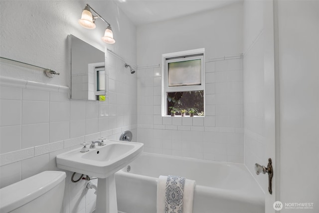 519 W Roy St Unit 211, Seattle, WA 98119 - full bathroom with shower / washtub combination, tile walls, and decorative backsplash