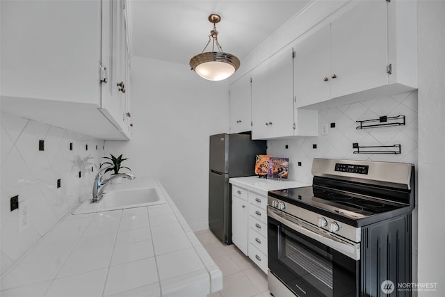 519 W Roy St Unit 211, Seattle, WA 98119 - kitchen featuring appliances with stainless steel finishes, decorative backsplash, white cabinets, and light tile patterned floors