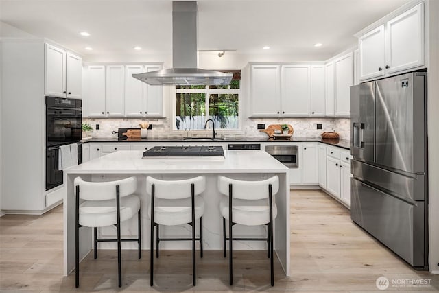 16432 SE 24th St, Bellevue, WA 98008 - kitchen with stainless steel fridge with ice dispenser, gas cooktop, island exhaust hood, a kitchen breakfast bar, and tasteful backsplash