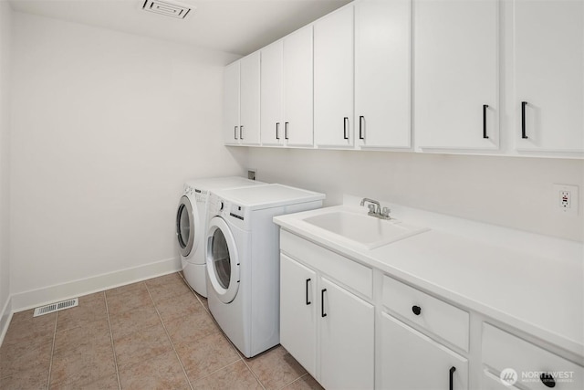 16432 SE 24th St, Bellevue, WA 98008 - laundry area with cabinet space, washing machine and clothes dryer, and light tile patterned floors